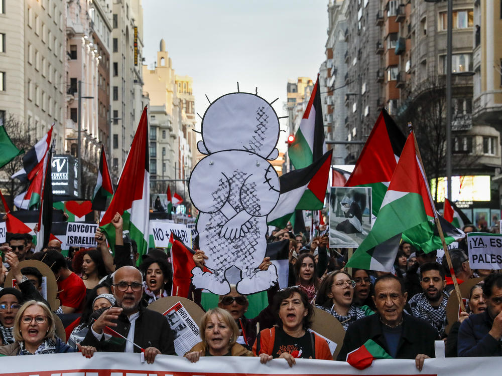 Demonstrators shout slogans and hold up an image of Handala, a symbol of Palestinian struggle, on Jan. 27 during a protest in Madrid in support of Palestinians and to demand a cease-fire in the Israel-Hamas war.