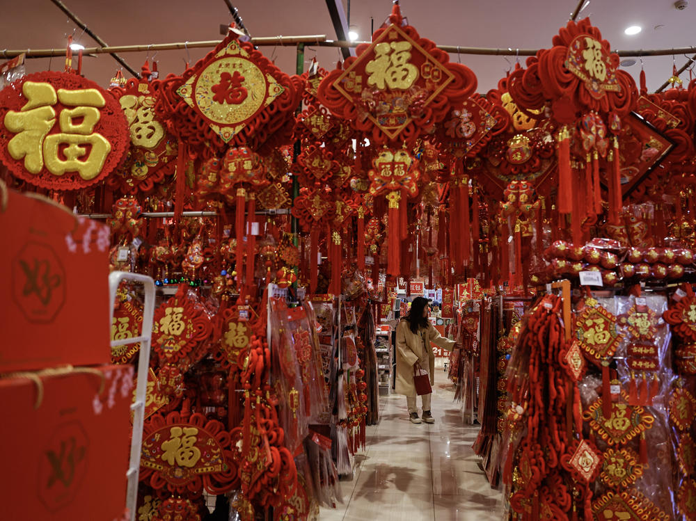 A shopper looks at Spring Festival couplet banners in a shopping mall on Jan. 31 in Wuhan, in China's Hubei province.