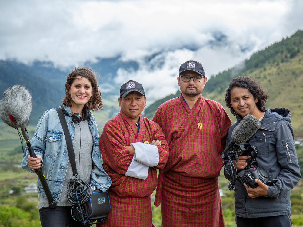 The new documentary <em>Agent of Happiness</em> follows Bhutanese bureaucrats who survey people about their state of mind. From right: director Dorottya Zurbó, happiness agents Amber Kumar Gurung and Guna Raj Kuikel, and director Arun Bhattarai.