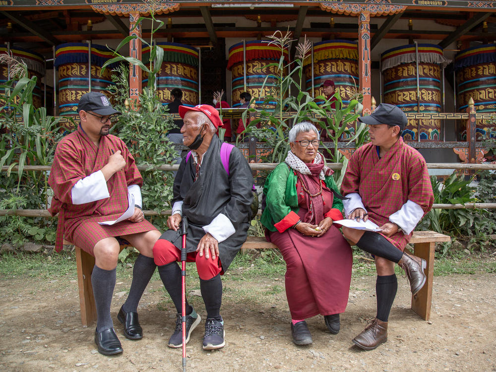 In a scene from the film, happiness agents Guna Raj Kuikel (left) and Amber Kumar Gurung (far right) ask folks a series of questions to measure how happy they really are.