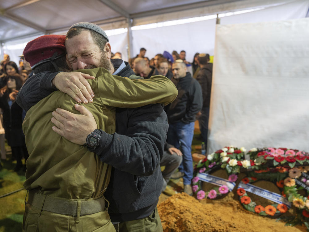 Mourners attend the funeral of reservist Gavriel Shani during his funeral at Mount Herzl military cemetery in Jerusalem on Wednesday, Jan. 31.