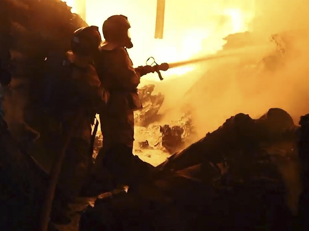 In this image made from video, firefighters work on a fire in Nairobi, Kenya, Friday, Feb. 2, 2024.