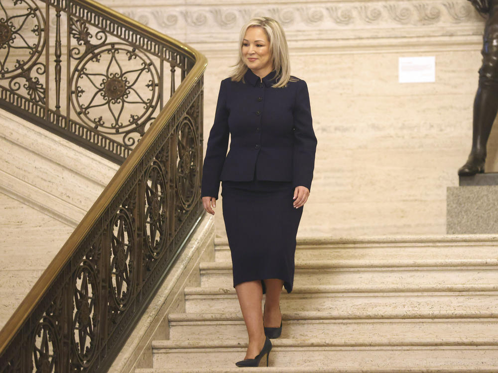 Sinn Fein Vice President Michelle O'Neill walks down steps at Stormont Parliament Buildings in Belfast, Northern Ireland, on Saturday. O'Neill made history by becoming the first Irish nationalist leader of Northern Ireland.