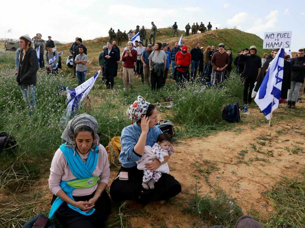 Protesters take part in a demonstration aimed at blocking trucks carrying humanitarian aid from entering Gaza, on the Israeli side of the Kerem Shalom border crossing with southern Gaza on Monday, Jan. 29.