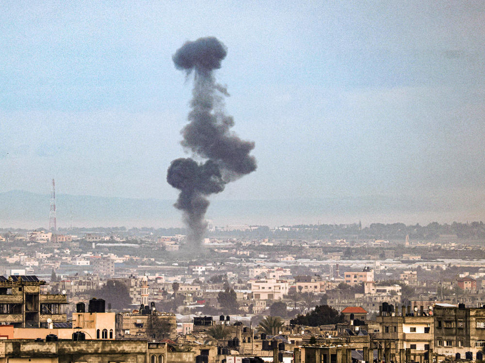 A picture taken from Rafah, in southern Gaza, shows smoke rising over buildings in Khan Younis during an Israeli bombardment on Friday, Feb. 2.