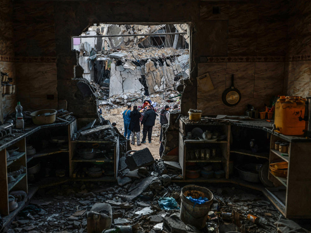 People survey the damage from an Israeli bombardment in Rafah, in southern Gaza, on Saturday, Feb. 3.