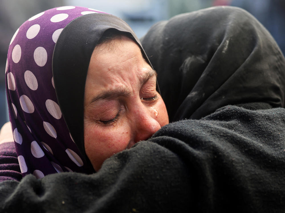 Women react upon identifying the body of a relative killed in an Israeli bombardment at Rafah's Najjar hospital on Saturday, Feb. 3.