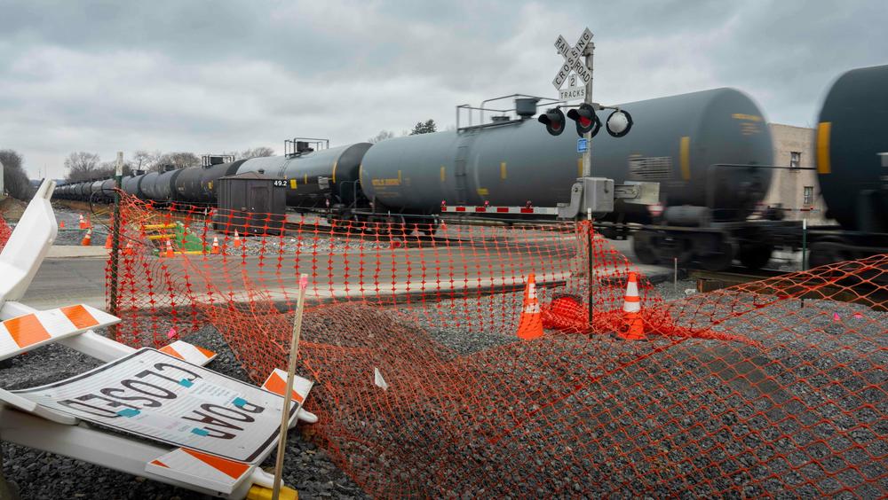 A freight train passes through East Palestine, Ohio, a year after the derailment.