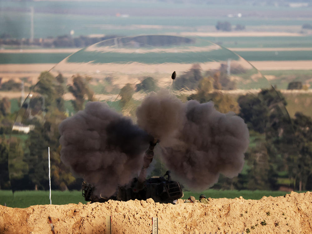 A shock wave is visible as an Israeli army self-propelled artillery fires a round from southern Israel toward the Gaza Strip on Thursday, Feb. 1.