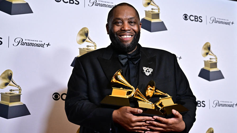 Killer Mike poses in the press room with the Grammys for best rap performance, best rap album and best rap song during the 66th annual Grammy Awards.