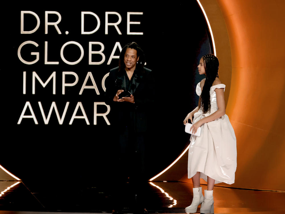 Jay-Z (left), accompanied by his daughter Blue Ivy Carter, accepts the honorary Dr. Dre global impact award at the 2024 Grammys.