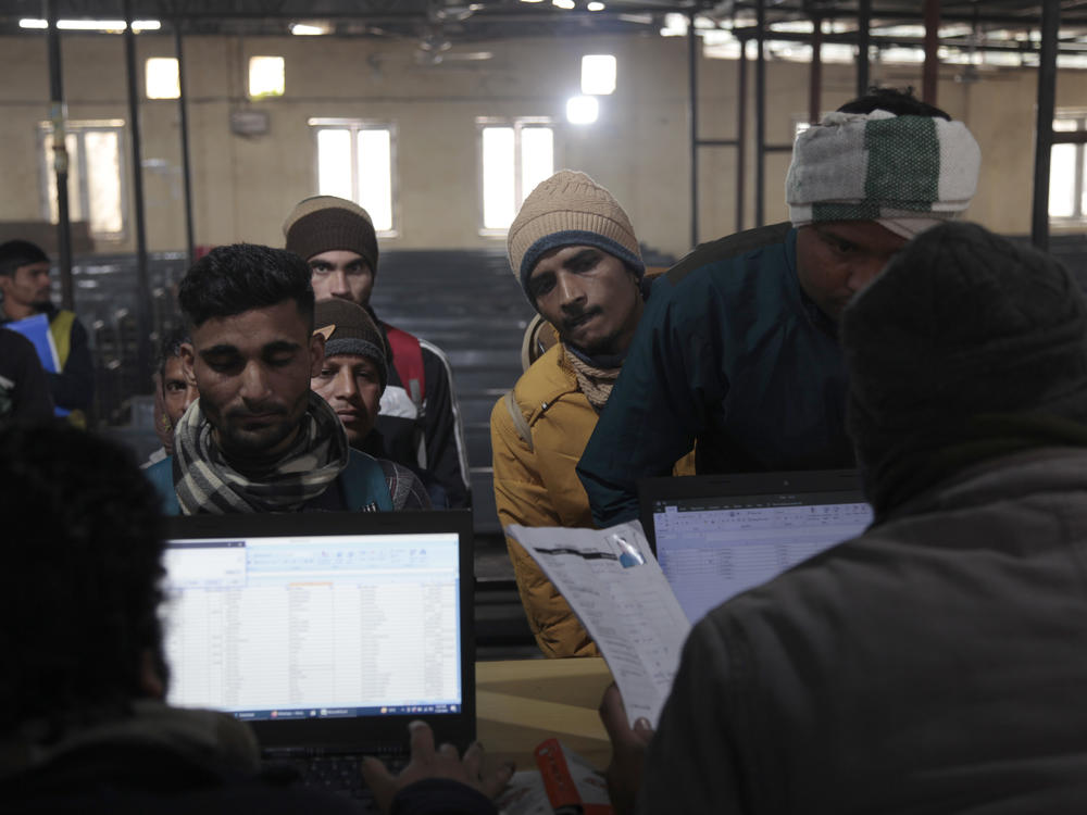 At a registration center in Lucknow, Indian men submit their data, as recruiters seek thousands of skilled laborers to work in Israel.