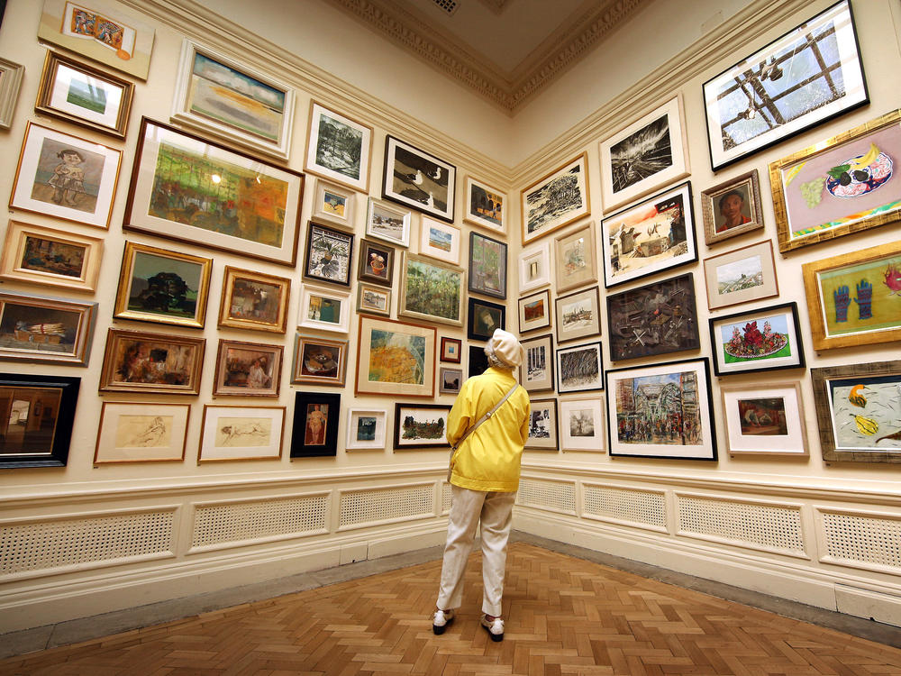 In her new book <em>Get the Picture, </em>journalist Bianca Bosker explores why connecting with art sometimes feels harder than it has to be. Above, a visitor takes in paintings at The Royal Academy Summer Exhibition in London in 2010.