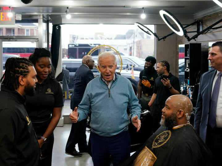 President Biden greets staff and patrons at Regal Lounge, a Men's Barber & Spa, in Columbia, S.C., before speaking at a political event in the area on Jan. 27.
