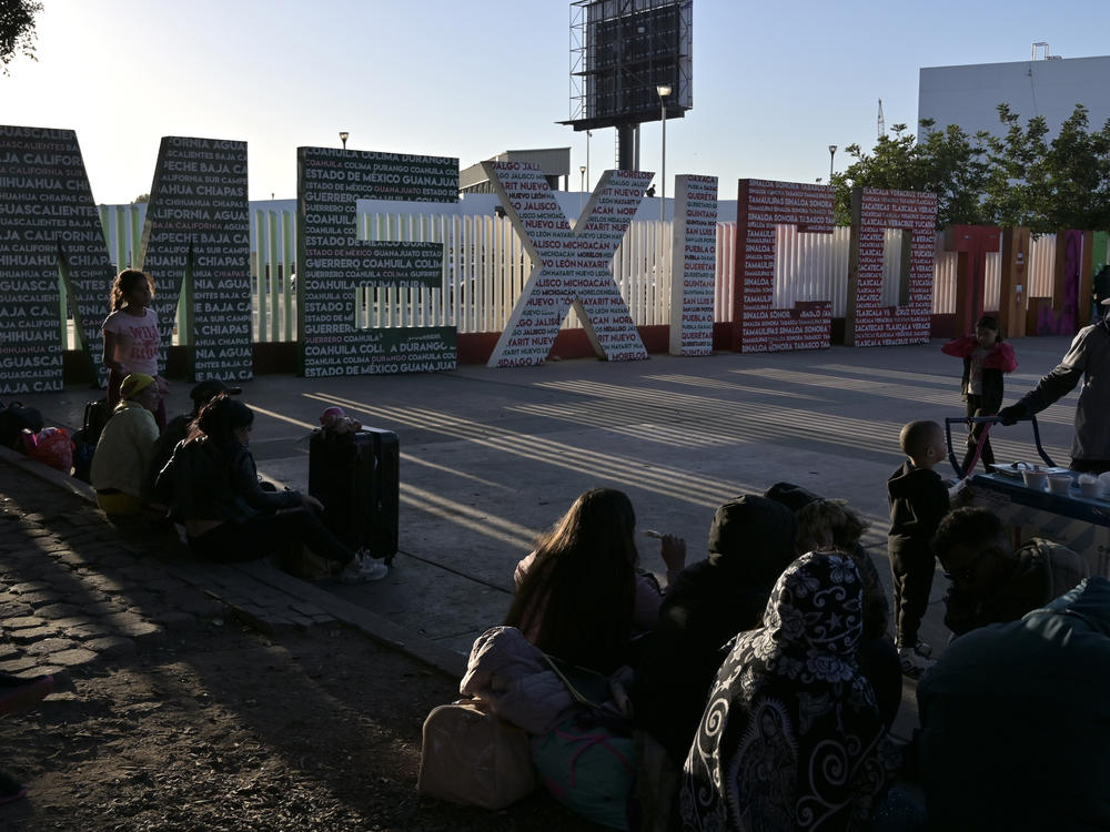 Migrants wait for their CBP One asylum appointment at the Chaparral pedestrian border in Tijuana, Mexico, on Nov. 8, 2023.