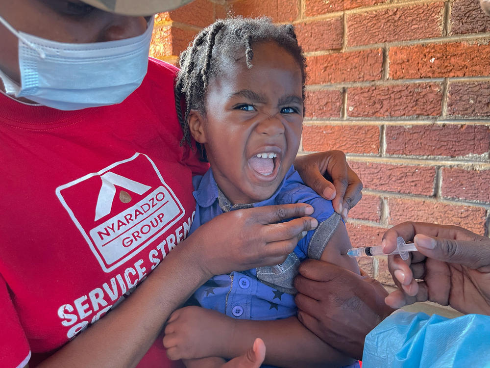 A child receives a measles vaccination at a clinic in Harare, Zimbabwe, where a 2022 outbreak saw some 700 children die from the highly infectious childhood disease.