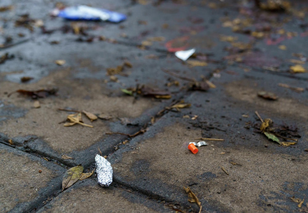 A sidewalk in downtown Portland, Ore., is dotted with tiny scraps of tinfoil, that police say are used for smoking fentanyl.