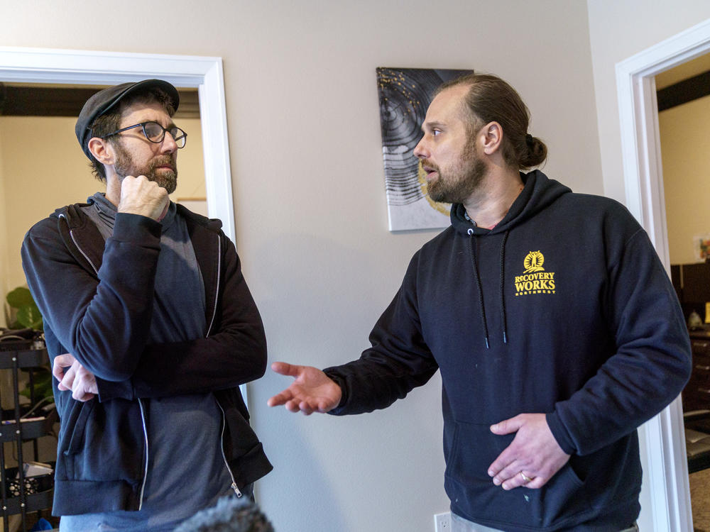 Recovery Works Northwest counselor Damian Thomas, left, talks with Joe Bazeghi, director of engagement for the organization, in the Portland, Ore. area.