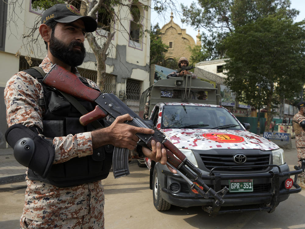Paramilitary soldiers stand guard on the side of a road for security, ahead of Feb. 8 general elections, in Karachi, Pakistan, Wednesday, Feb. 7, 2024.