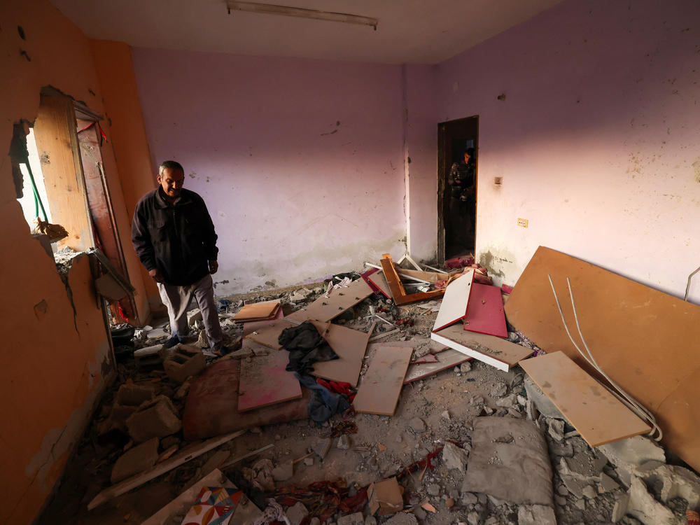 Men check a home destroyed by Israeli bombardment in a Rafah refugee camp in the south Gaza Strip, on Jan. 1, amid the ongoing conflict between Israel and Hamas.
