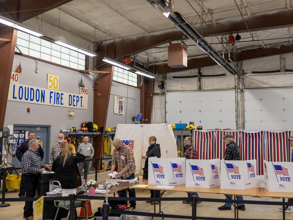 Voters wait to cast their ballots on Jan. 23 in Loudon, N.H. Shortly before voting began, some voters in the state got calls from a faked version of President Biden's voice urging them not to vote, a sign of the potential that deepfakes could have on the electoral process.