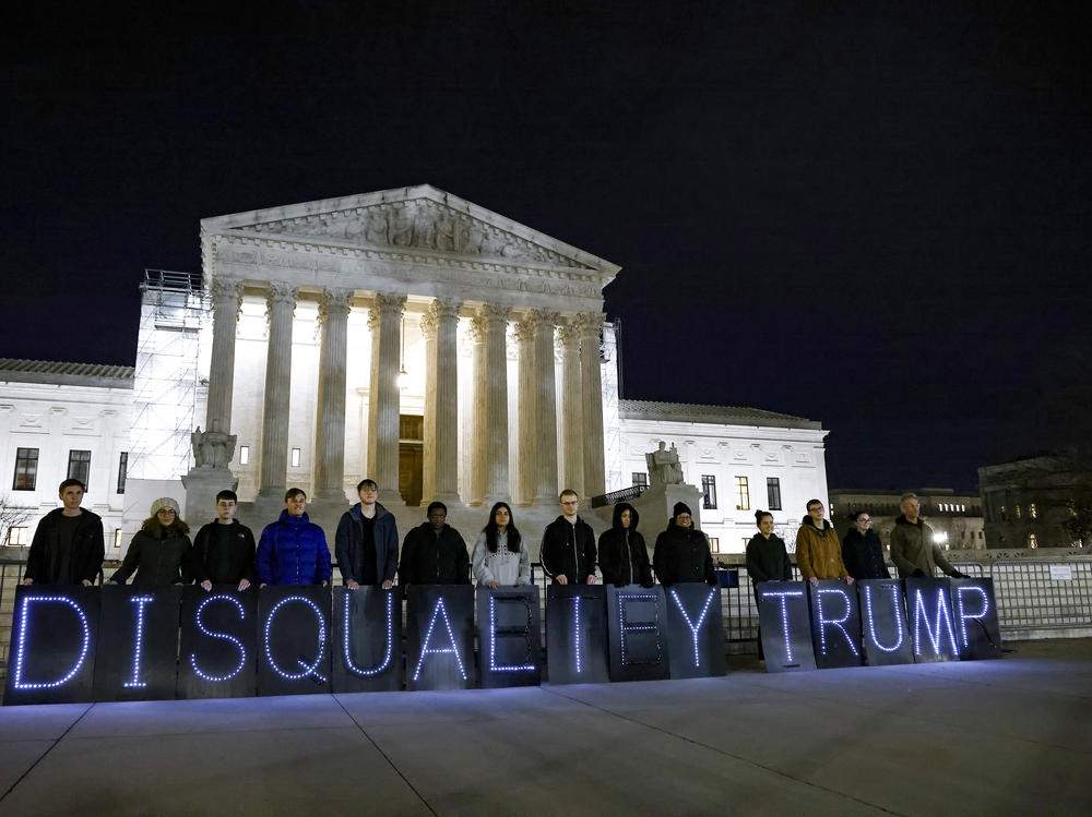MoveOn members hold signs that read 