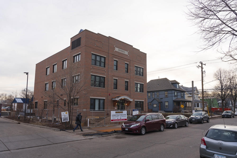 The Sundial is located between neighborhood houses and a larger mixed-use building along Nicollet Avenue.