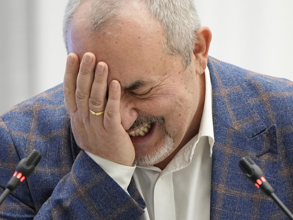 Boris Nadezhdin, a liberal Russian politician who is seeking to run in the March 17 presidential election, laughs during a meeting of the Russia's Central Election Commission in Moscow, Thursday.