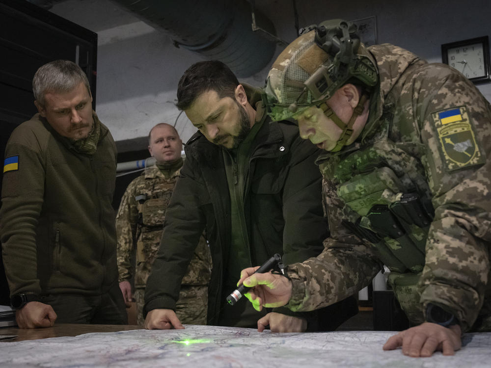 Ukrainian President Volodymyr Zelenskyy (center) and commander of Ukraine's ground forces, Col.-Gen. Oleksandr Syrsky (right), look at a map during their visit to the front line city of Kupiansk, Kharkiv region, Ukraine, on Nov. 30, 2023. Oleksandr Syrsky was appointed as new commander-in-chief of Ukraine's Armed Forces.