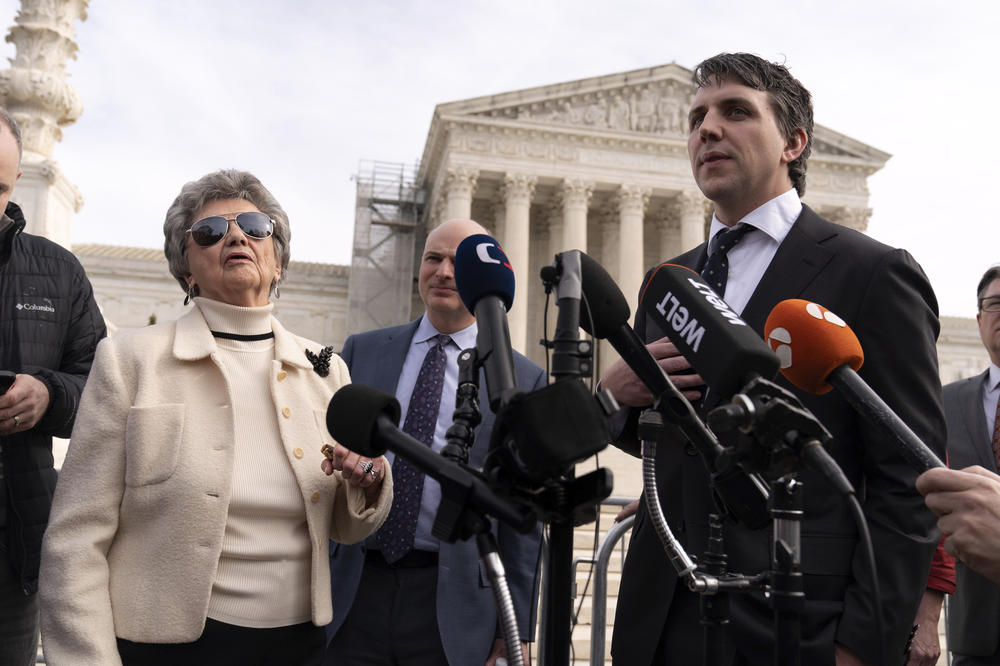 Jason Murray (right), the lead attorney behind the lawsuit by six Colorado voters, and the lead plaintiff, Norma Anderson, speak with reporters after Thursday's U.S. Supreme Court arguments.