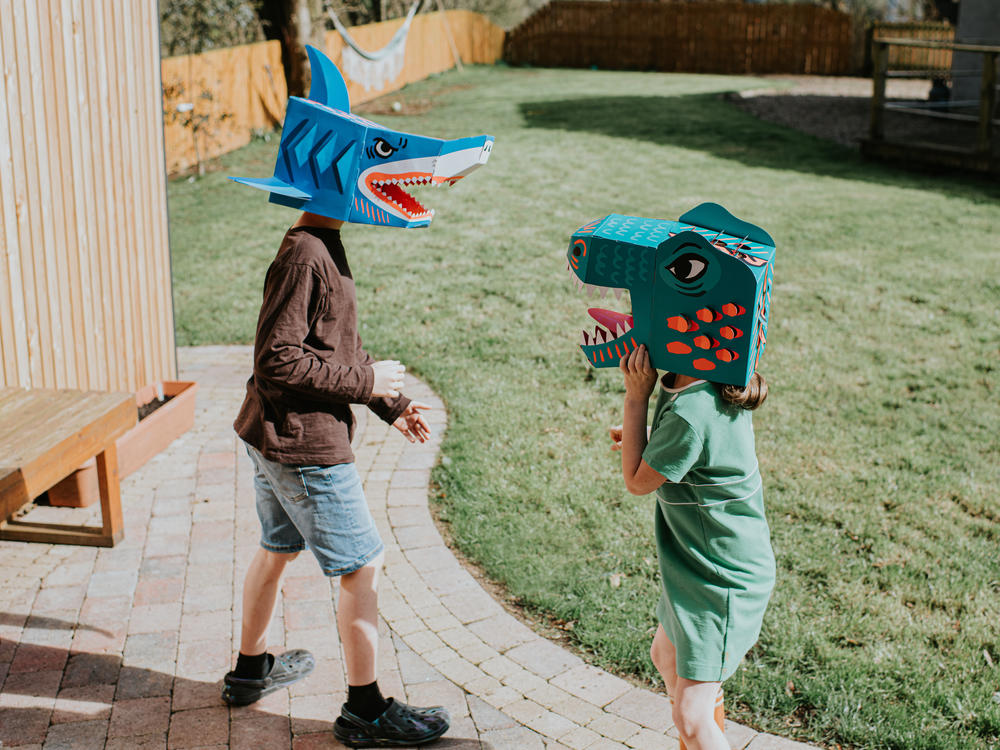 A brother and sister enjoy an imaginative game in a domestic garden on a sunny day. Siblings can have a powerful effect on one another.