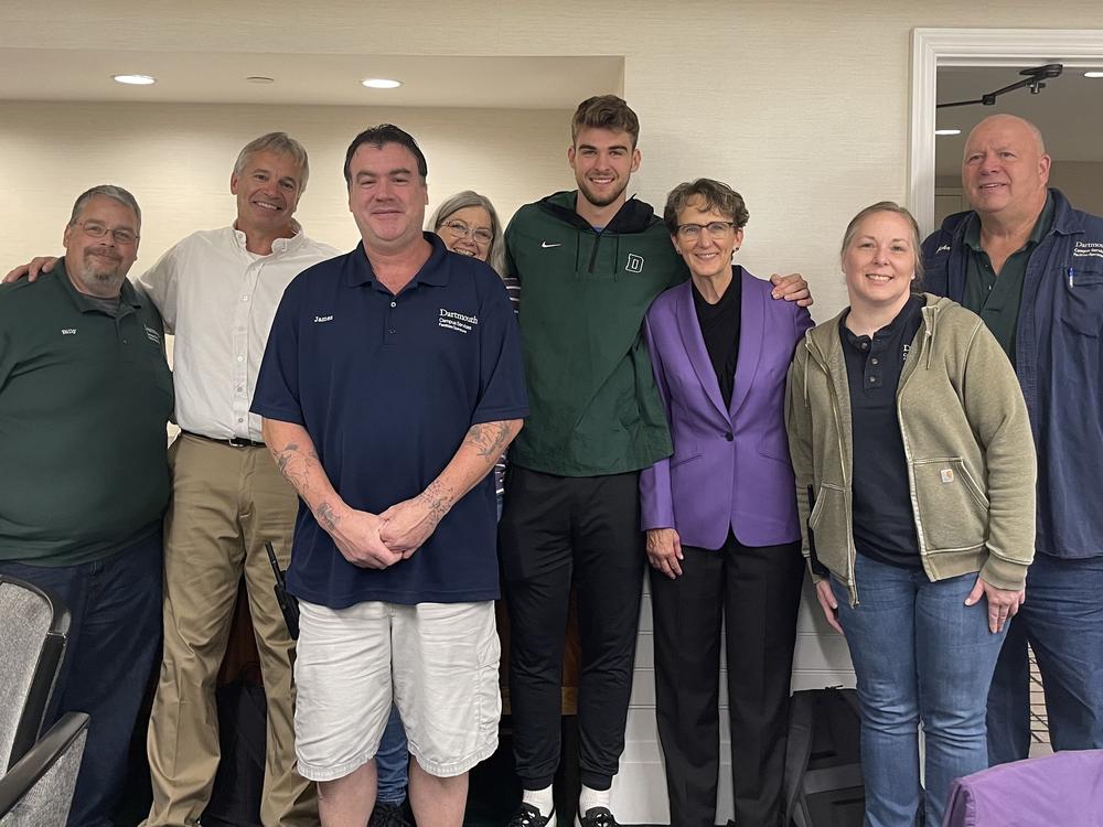 Dartmouth forward Cade Haskins (center) stands with SEIU President Mary Kay Henry (in purple blazer) and members of SEIU Local 560, the Dartmouth College Employees' Union. Haskins and his teammates are expected to vote soon on whether to join Local 560.