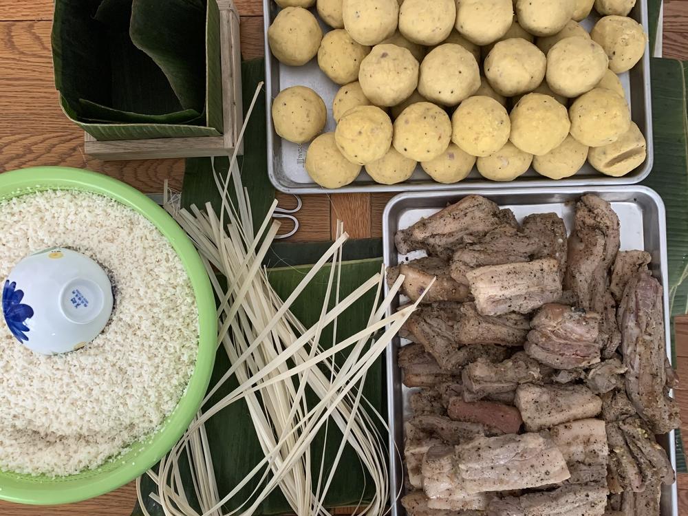 Making banh chung involves a labor intensive process. Often, the entire family is roped in to help.