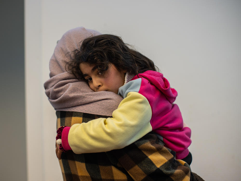 Rana holds her daughter Misk, 5, at their home in Ramallah.