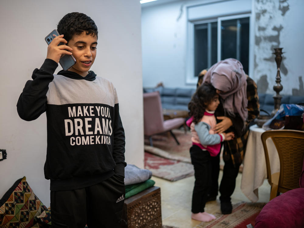 Ibrahim, 12, speaks to his grandmother, who lives in Gaza, from his home in Ramallah in the Israeli-occupied West Bank on Jan. 31. The family did not want to use their full names out of fear of reprisals from Israeli authorities.