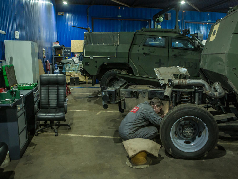 A worker repairs a military vehicle in the armored car repair shop of the Ukrainian Armor Design and Manufacturing Co.