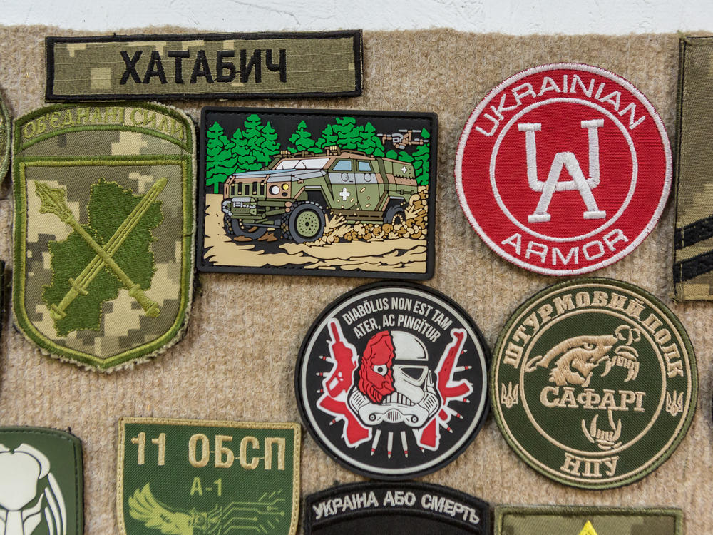 Military patches, including of the Novator armored personnel carrier, are seen at the armored car repair shop of the Ukrainian Armor Design and Manufacturing Co.