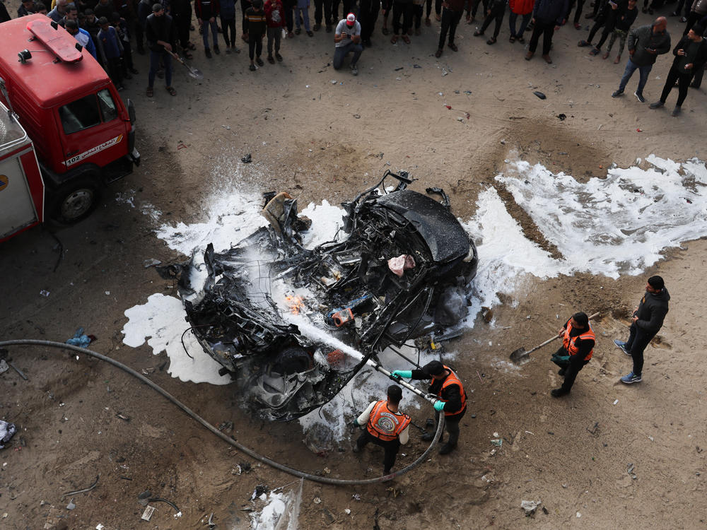 Rescuers put out a fire after a car was hit by an Israeli strike on Rafah on Saturday, Feb. 10.