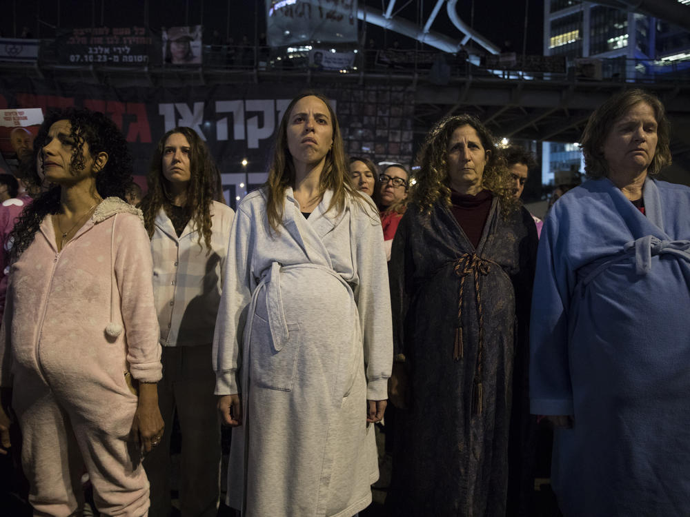 Protesters disguised as pregnant women take part in a demonstration in Tel Aviv, calling for the release of hostages held by Hamas in Gaza, on Thursday, Feb. 8.