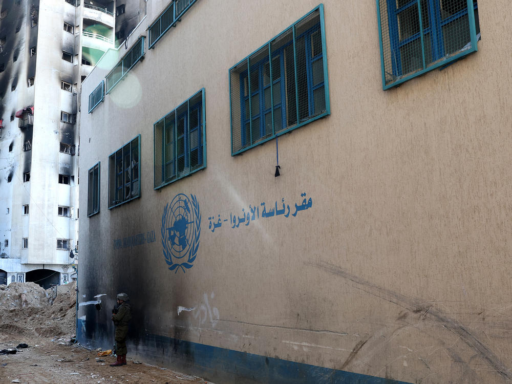 An Israeli soldier standing in front of a United Nations Relief and Works Agency for Palestine Refugees (UNRWA) building in Gaza City. This photo was taken during a controlled tour by the Israeli army on Feb. 8 and subsequently edited under the supervision of the Israeli military.