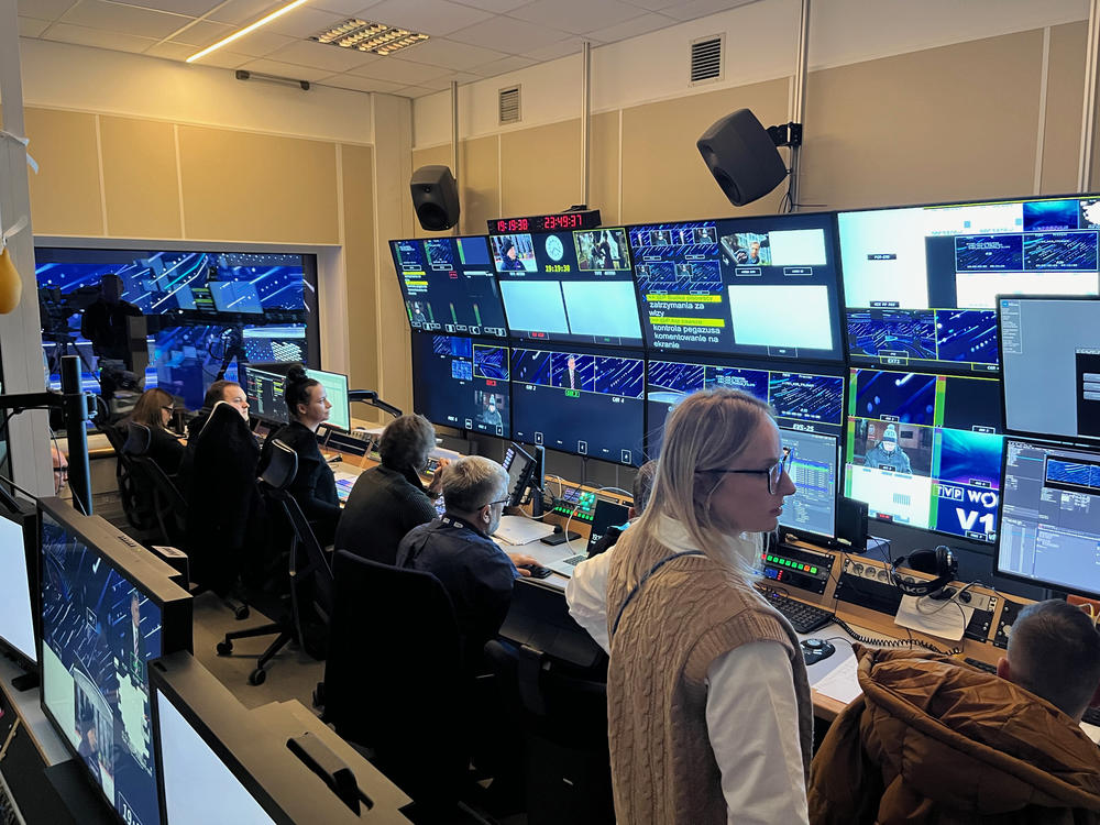 The production team of the TVP Info program <em>19.30</em> directs a live broadcast from a temporary studio on the outskirts of Warsaw while their normal Warsaw studio is being cleared of Law and Justice party lawmakers who refused to leave the building in protest of the new government's changes to TVP.