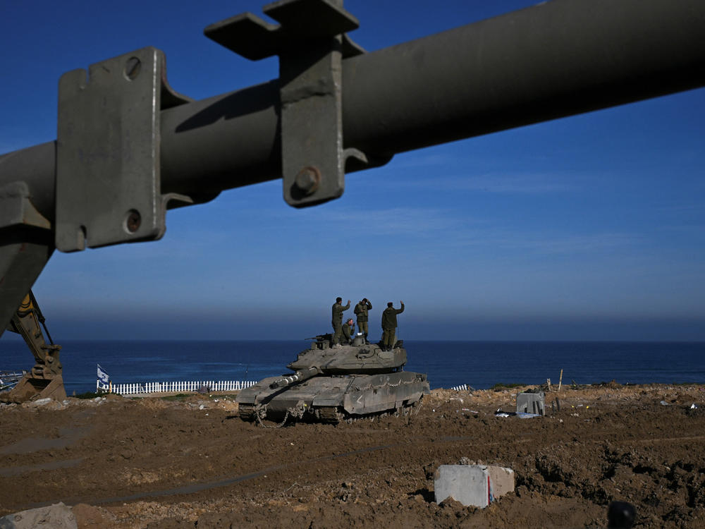 Israeli soldiers stand on a tank near the sea in the Gaza Strip on Thursday, Feb. 8.