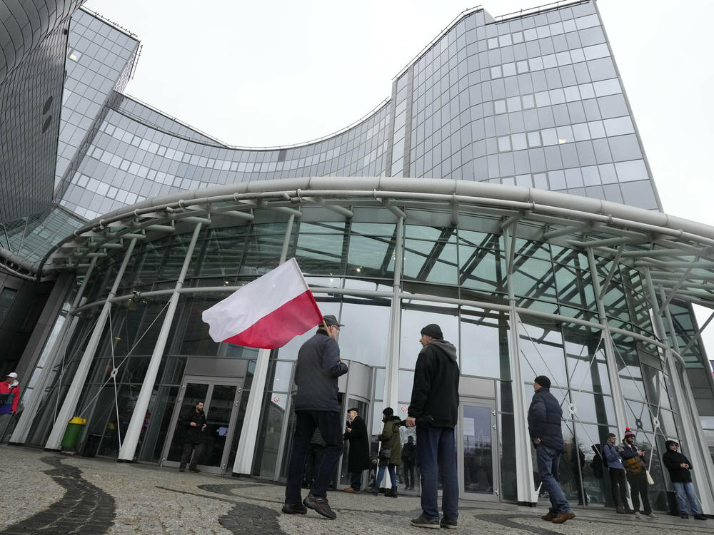 Supporters of the outgoing Law and Justice party protest outside the headquarters of Poland's state-owned TVP broadcaster after the new government took control last December.