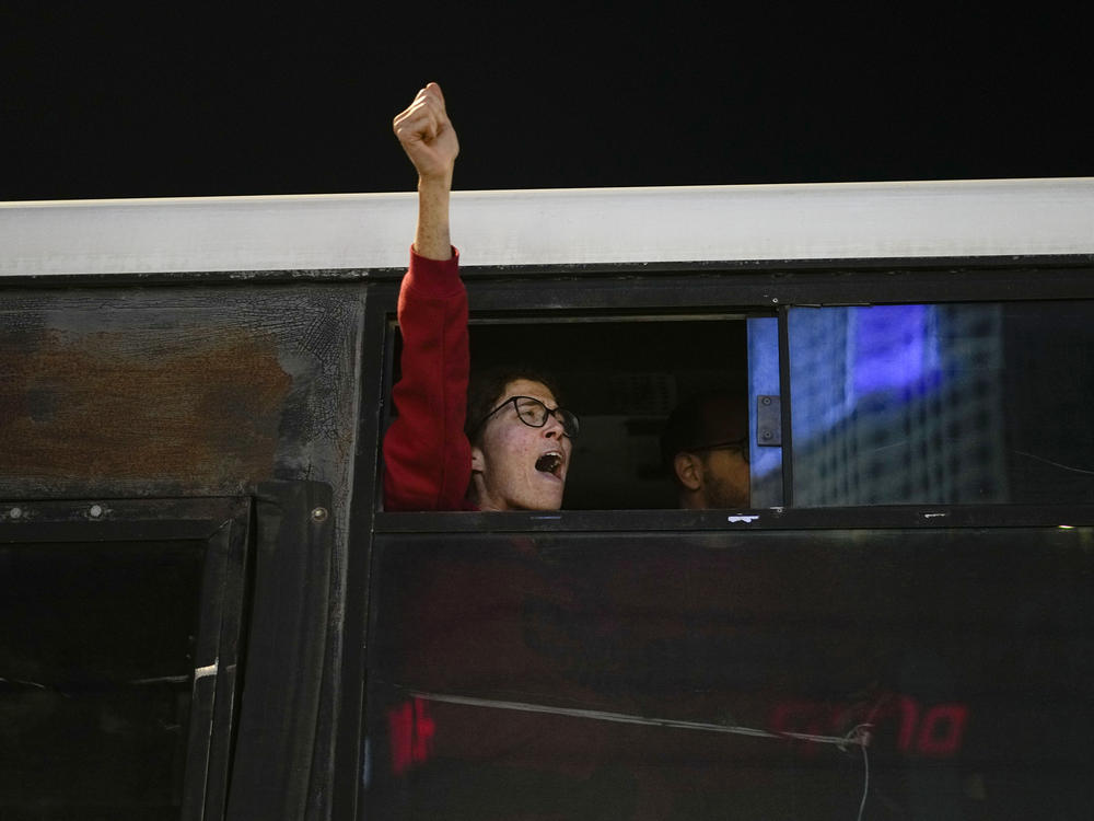 A woman shouts slogans after being detained by the police in Tel Aviv on Saturday, Feb. 10, during a protest to demand the release of the hostages taken by Hamas militants during the Oct. 7 attack.