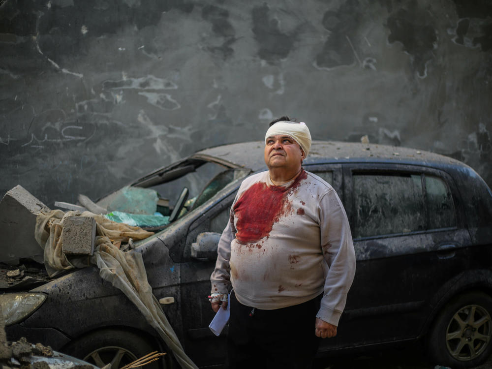 People survey the damage to their homes caused by Israeli airstrikes in Rafah on Wednesday, Feb. 7. There are mounting concerns over an Israeli Defense Forces ground invasion of Gaza's southern city of Rafah, where over a million internally displaced Palestinians are sheltering, as the U.N. warns of a potential 