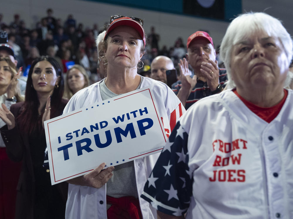 Trump supporter Christi McCuiston (center) of Elon, N.C., listens with other attendees as Trump speaks at a rally at Coastal Carolina University on Feb. 10.
