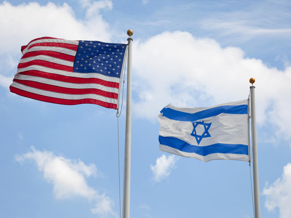 U.S. and Israeli flags wave together. Nearly half of U.S. Jewish respondents to a survey commissioned by the American Jewish Committee say they've changed their behavior due to fear. The survey was conducted in October and November 2023.
