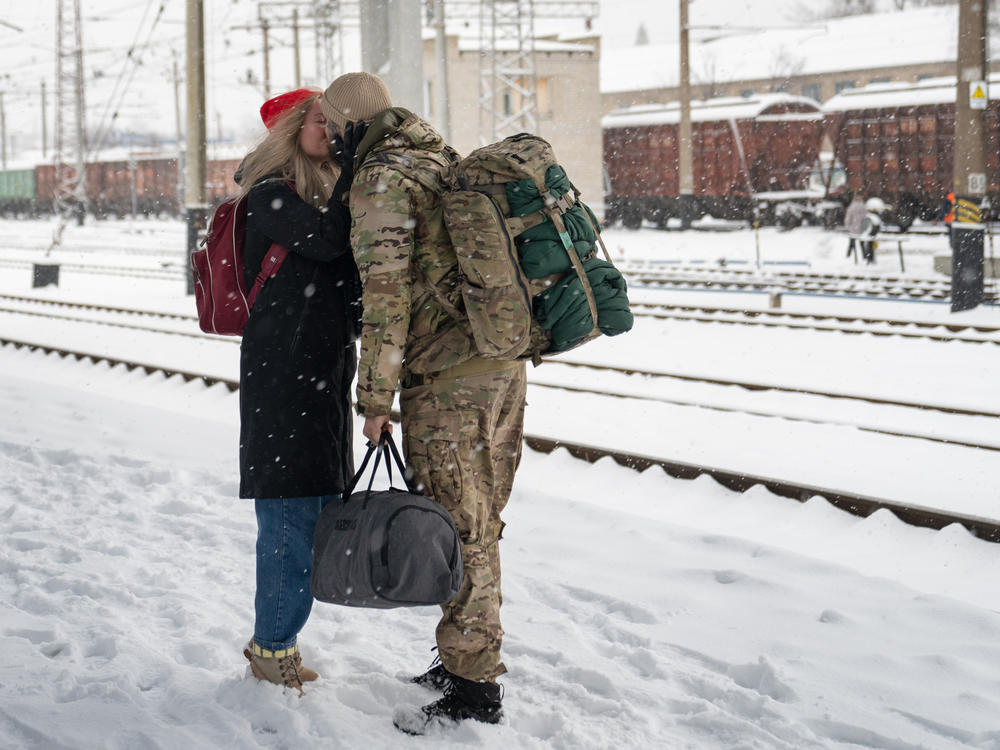 A soldier meets his partner at the train station in Sloviansk, in eastern Ukraine, ahead of Valentine's Day.