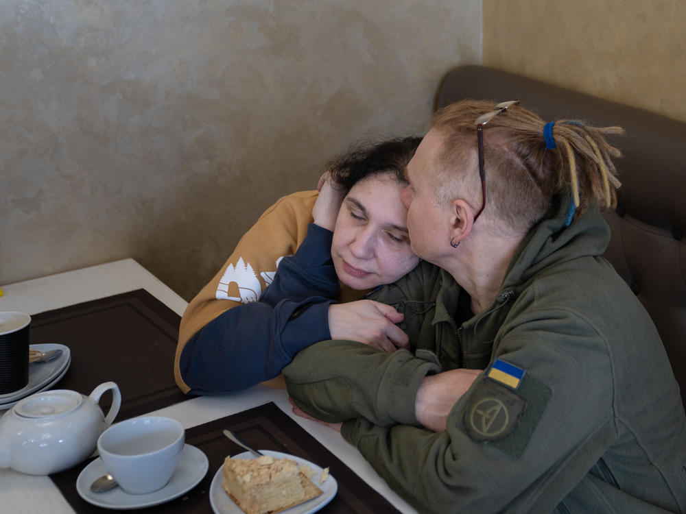 Yulya Dmytrieeva and her husband, Vadym, sit together at a cafe to warm up on a snowy day.