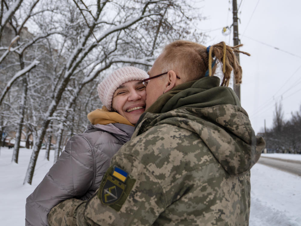 Yulya Dmytrieeva and her husband, Vadym, who have been together for over a decade, embrace in the snow in Sloviansk. They will spend a few days together while he has a break from the trenches on the front lines.